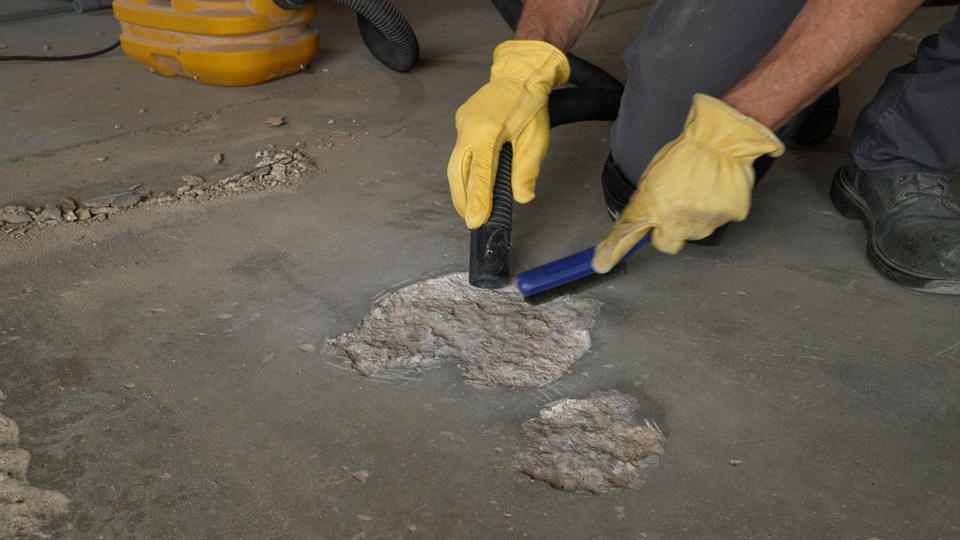removing dust and debris with a wire brush and vacuum